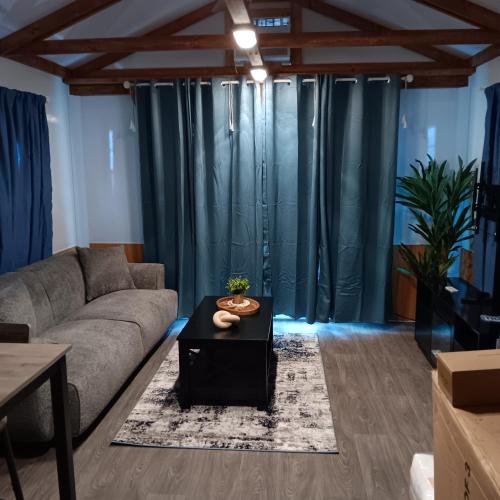 a living room with a couch and a table at Aqua Lodges At Hurricane Hole Marina in Key West