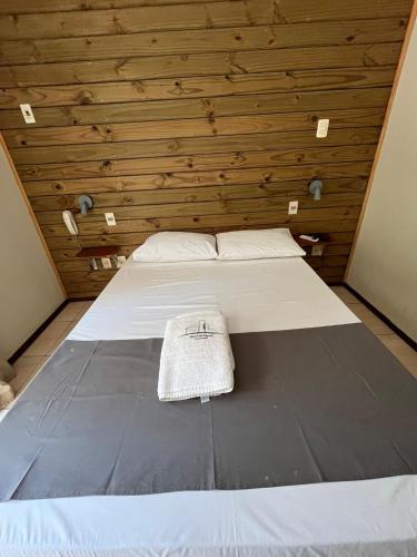 a bed with a hat sitting on top of it at Hotel Mirador del Dayman in Termas del Daymán