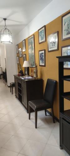 a waiting room with a chair and a desk at Casa los Tres Aires in El Rocío