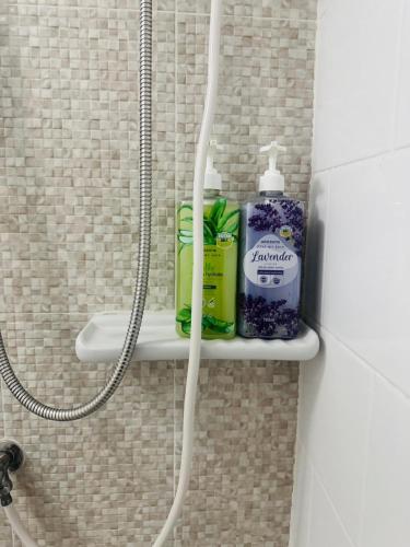 a shower shelf with toiletries on it in a bathroom at 1 Bedroom Next to IKEA,Central Westgate46 in Ban Bang Krabu