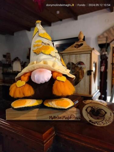 a stuffed animal wearing a banana hat on a table at MolinDeiMaghi in Fondo