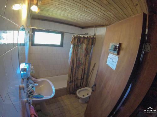 a small bathroom with a sink and a toilet at el refugio de caniche in Caviahue