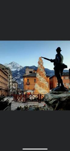 a statue of a man holding a gun next to a christmas tree at La Vigne de Papagran in Aosta