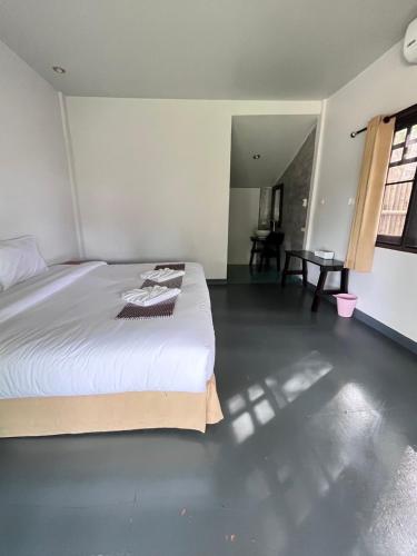 a bedroom with a large white bed in a room at Long Beach Club Krabi in Ao Nang Beach