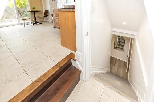a hallway with a tile floor and a fireplace at Cozy Modern 4BR Home with Sunny Patio in Ottawa