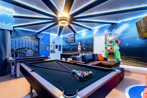 a billiard room with a pool table and a monster at Upstay - Magic Mansion w Pool-Spa-Cinema-Games in Kissimmee