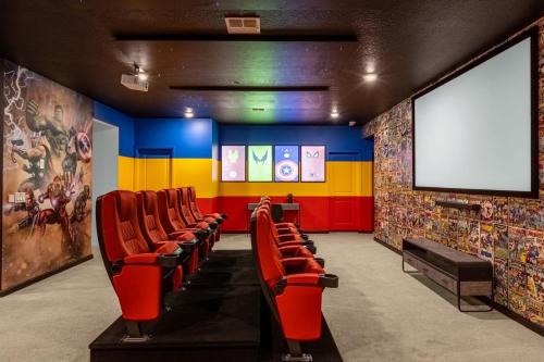 a waiting room with red chairs and a screen at Upstay - Magic Mansion w Pool-Spa-Cinema-Games in Kissimmee