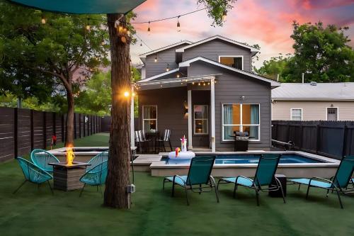 a backyard with a pool and chairs and a house at Downtown Austin Oasis w Pool & Hot Tub - Sleeps 18 in Austin