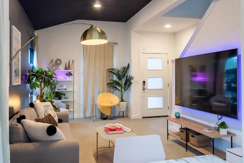 a living room with a couch and a large screen tv at Downtown Austin Oasis w Pool & Hot Tub - Sleeps 18 in Austin