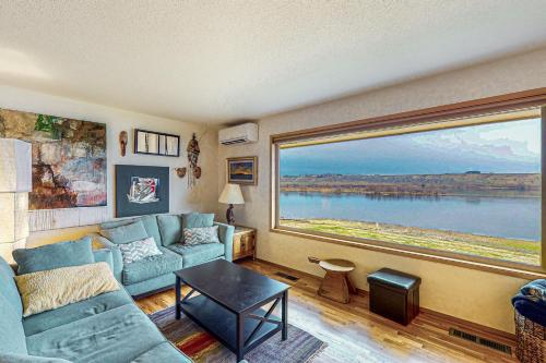a living room with a couch and a large window at Columbia Vista in Richland