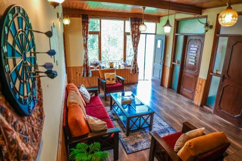 a living room with a dart board on the wall at The Manu Emerald # farmHouse # top selling cottage in manali # peaceful heritage cozy stay # lawn with bonfire # most awarded in Manāli