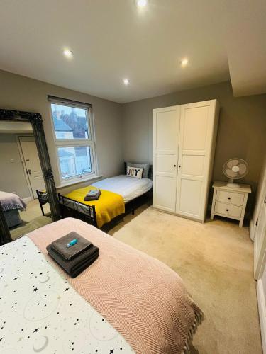 a bedroom with two beds and a window at Brentford Guest Rooms in Brentford