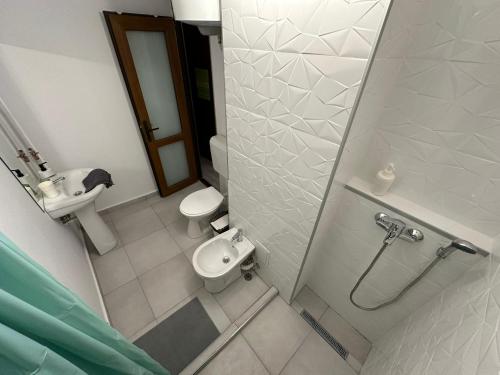 a small bathroom with a toilet and a sink at New Green Apartment Studio 1 in Bucharest