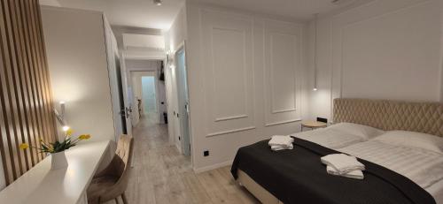 a bedroom with a bed with two towels on it at Anita's Mansion in Gattendorf