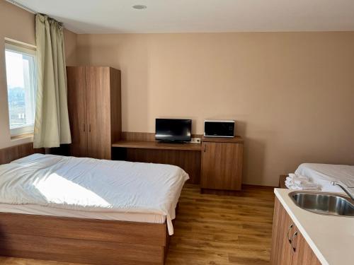 a bedroom with a bed and a sink in it at Apartment Sofia Airport free shuttle and parking in Sofia