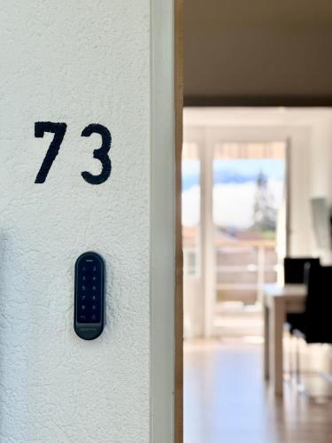 a door with a remote control in a room at JJ Living - Alpenblick 073 in Scheidegg