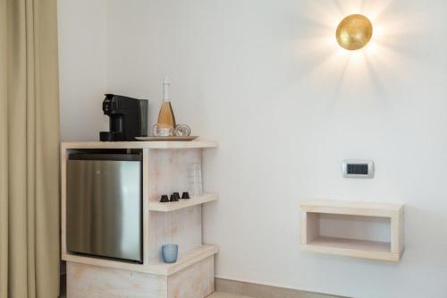 a living room with a tv on a wall at Villa Giulia suite in Àrbatax