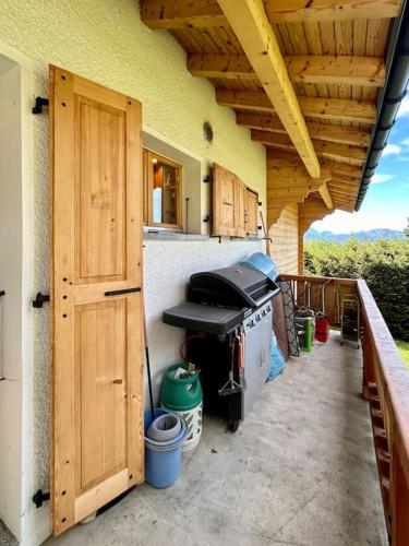 an outdoor kitchen with wooden doors and a stove at Peace & comfort - Great views and location in Villars-sur-Ollon