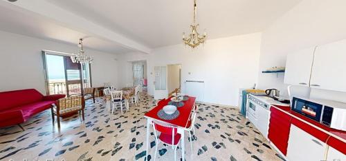 a kitchen and living room with a red table in it at Bed & Breakfast StudioArcodia- in San Marco dʼAlunzio