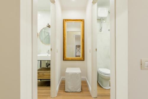 a bathroom with a toilet and a mirror at Pantheon Apartments - Piccola Roma in Rome