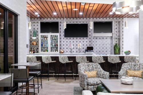 a bar in a restaurant with chairs and tables at Fairfield by Marriott Inn & Suites Buckeye Verrado in Buckeye