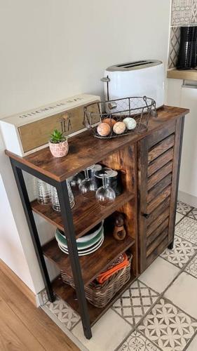 a counter in a kitchen with a table with dishes at La grange de la Bâtie in Fay-le-Clos