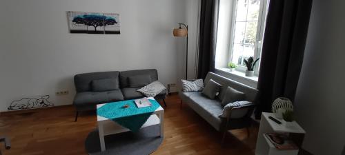 a living room with a couch and a table at Fewo Nied in Rehlingen-Siersburg