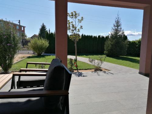 a patio with two chairs and a view of a yard at Landhaus Olive in Čitluk