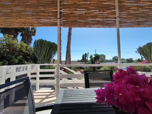 a porch with a bench and a bunch of flowers at Sicilia Noto San Lorenzo Villa Amaranto in San Lorenzo