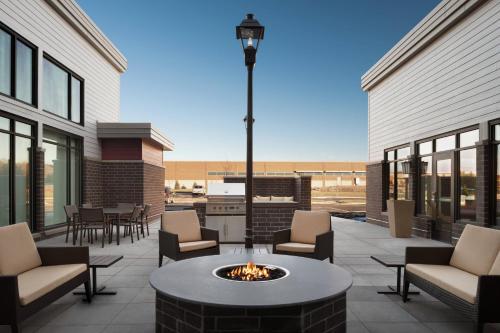 a patio with a fire pit and chairs and tables at Residence Inn by Marriott Minneapolis St. Paul/Eagan in Eagan