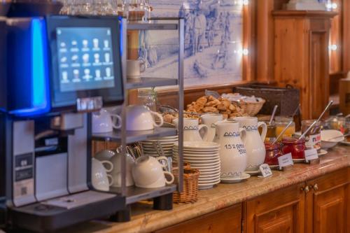 a counter with dishes and cups and plates on it at Strandhotel Heringsdorf in Heringsdorf