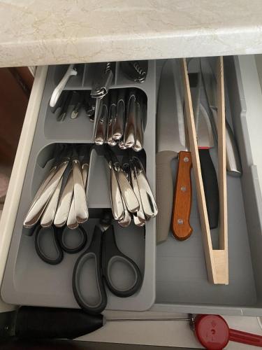a drawer filled with lots of scissors and a guitar at Next to the Ski Lift Downtown Bansko in Bansko
