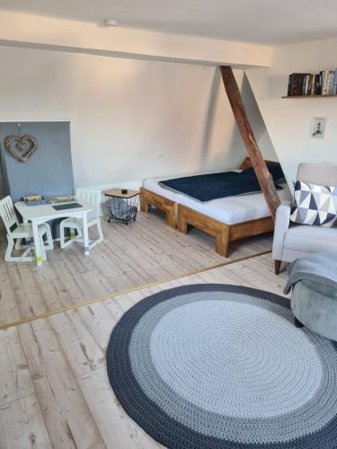 a bedroom with a bed and a rug on the floor at Ferienwohnung Schnelzer in Sahlenburg