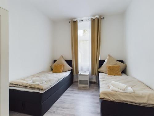 Ένα ή περισσότερα κρεβάτια σε δωμάτιο στο ElbeLounge Magdeburg