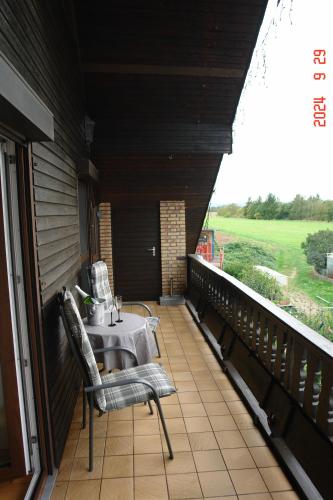 a room with a table and chairs on a balcony at Ferienwohnung in Sponsheim in Bingen am Rhein