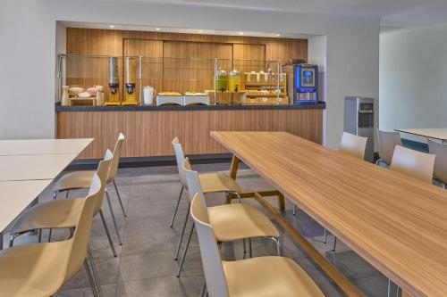 a conference room with a wooden table and chairs at City Express by Marriott Mexicali in Mexicali