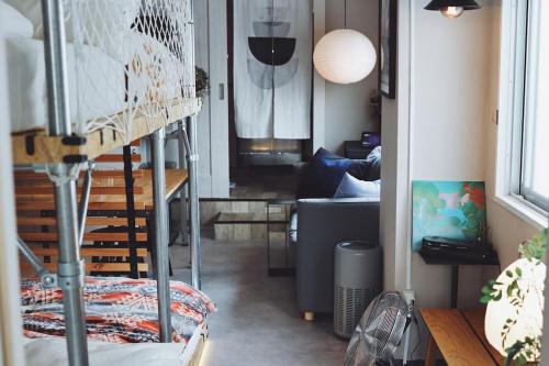 a room with a bunk bed and a couch at ワンフロア貸切デザイナーズルーム 新宿まで10分 in Tokyo