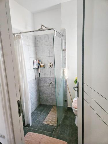a bathroom with a shower and a toilet at De Pearl Home Tatu City - Nairobi in Nairobi