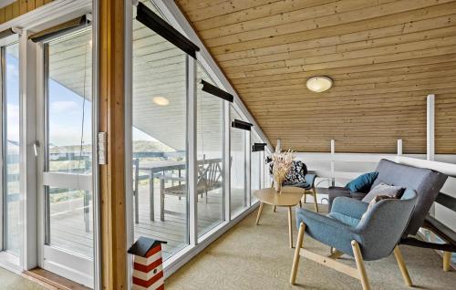 a room with a balcony with chairs and a table at Awesome Home In Thisted With Sauna in Thisted