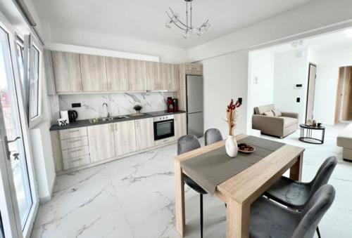 une cuisine avec une table et des chaises dans une pièce dans l'établissement Ionia's Comfort Appartments -2nd floor, à Athènes