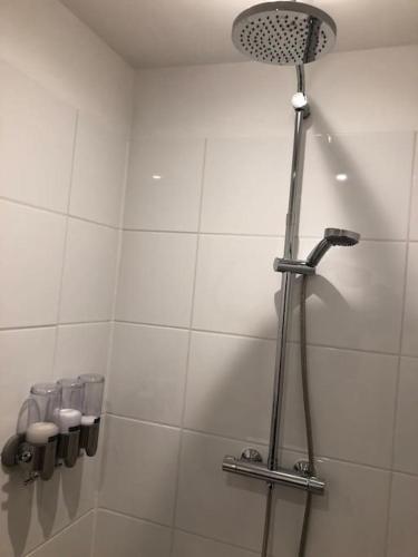 a shower in a bathroom with a shower head at Luxurious appartement with sauna and kitchen in center of Dordrecht in Dordrecht