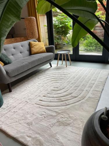 a living room with a couch and a table at Luxurious appartement with sauna and kitchen in center of Dordrecht in Dordrecht