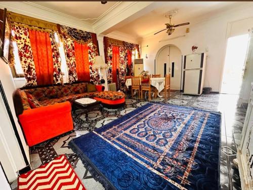 a living room with a couch and a rug at Nuba Dool in Aswan