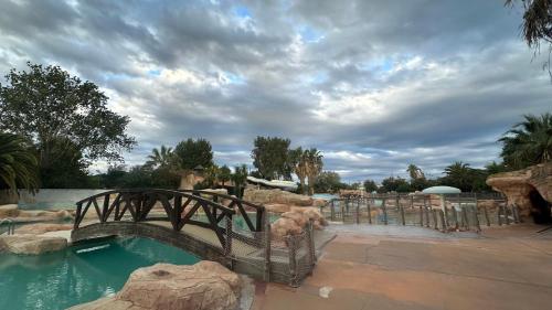 - un pont au-dessus d'une piscine dans un complexe dans l'établissement Mobil-home neuf tout confort - Camping 4 étoiles les sables d or - Le Cap d Agde, au Grau-dʼAgde