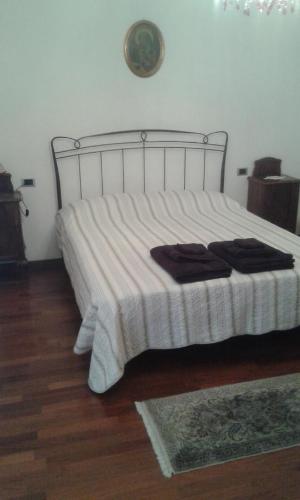 a bedroom with a bed with a white comforter at B&B Cascina Baraggione in Granozzo con Monticello