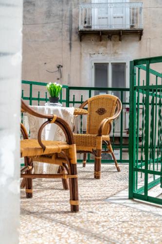 a table and chairs sitting on a balcony at La casa di Nina in Monte di Procida