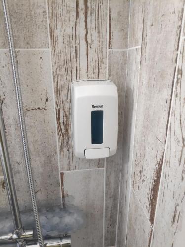a soap dispenser on the wall of a bathroom at Casa de porto covo 2 in Porto Covo