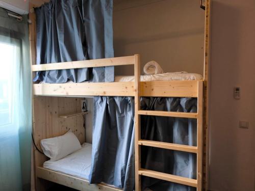 a couple of bunk beds in a room at Casa de porto covo 2 in Porto Covo