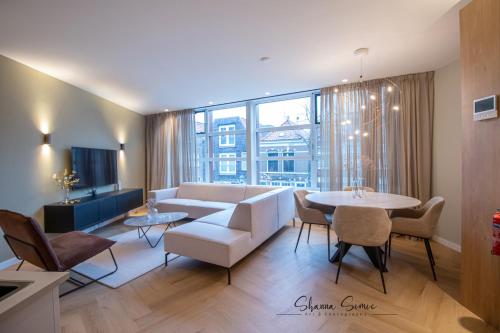 a living room with a couch and a table at ApartHotel Boutique by Urban Home Stay in Alkmaar