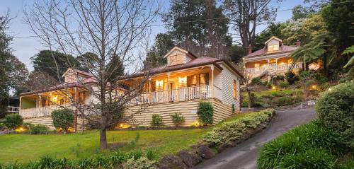 a large wooden house with its lights on at Charnwood Cottages in Warburton in Warburton